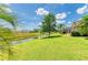 Expansive backyard with a tranquil canal view, providing a serene outdoor setting at 169 Fairway Rd, Rotonda West, FL 33947