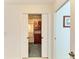 Walk in closet showcasing ample storage space with wooden shelves and cabinetry at 169 Fairway Rd, Rotonda West, FL 33947