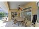 Relaxing covered patio featuring a dining table, chairs, ceiling fan, and sliding glass doors at 169 Fairway Rd, Rotonda West, FL 33947