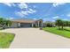 Beautiful home with a well-kept lawn, driveway, and screened garage, perfect for any Gathering at 169 Fairway Rd, Rotonda West, FL 33947