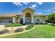 Charming single-story home with manicured lawn and a decorative front water fountain at 169 Fairway Rd, Rotonda West, FL 33947