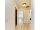 Hallway showcasing a neutral color palette, wood-look floors, and access to other rooms at 169 Fairway Rd, Rotonda West, FL 33947
