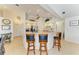 Open kitchen design with bar stool seating, stainless steel appliances, and neutral countertops at 169 Fairway Rd, Rotonda West, FL 33947