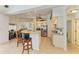 Open kitchen design with bar stool seating, stainless steel appliances, and neutral countertops at 169 Fairway Rd, Rotonda West, FL 33947