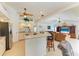 An open concept kitchen with stainless steel appliances, a breakfast bar, and tile flooring at 169 Fairway Rd, Rotonda West, FL 33947