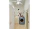 Functional laundry room with a washer, dryer, storage shelves, and an ironing board at 169 Fairway Rd, Rotonda West, FL 33947