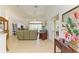 Cozy living room features tile flooring, high ceilings, and a view of the screened lanai at 169 Fairway Rd, Rotonda West, FL 33947