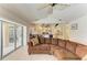 An open living area featuring tile floors, access to the kitchen, and a view of the pool at 169 Fairway Rd, Rotonda West, FL 33947