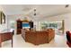Cozy living room with large windows and sliding doors overlooking the pool area at 169 Fairway Rd, Rotonda West, FL 33947