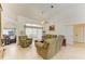 Bright living room with vaulted ceilings, tile floors, and sliding glass doors to the outdoor space at 169 Fairway Rd, Rotonda West, FL 33947