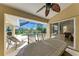 Covered patio offering an outdoor dining area, lounge chairs, ceiling fan, and access to the pool at 169 Fairway Rd, Rotonda West, FL 33947
