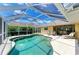 Private screened-in pool with lounge chairs offering a relaxing outdoor retreat at 169 Fairway Rd, Rotonda West, FL 33947