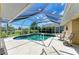 Screened in pool with lounge chairs perfect for relaxing on a sunny day at 169 Fairway Rd, Rotonda West, FL 33947