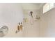 Updated tile shower with modern showerhead and convenient shelving at 169 Fairway Rd, Rotonda West, FL 33947