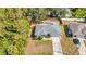 Aerial view of the home featuring a well-manicured lawn and tree lined street at 1962 Remus Ave, North Port, FL 34286