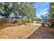 Spacious backyard with mature trees providing ample shade and privacy for outdoor activities at 1962 Remus Ave, North Port, FL 34286