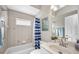Bright bathroom featuring a shower-tub, a sink, and a window for natural lighting at 1962 Remus Ave, North Port, FL 34286
