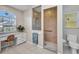 Bright bathroom with a walk-in shower, a vanity, and a window with natural light at 1962 Remus Ave, North Port, FL 34286