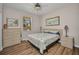 Charming bedroom with a dresser, nightstands, and a cozy bed with sea-themed decor at 1962 Remus Ave, North Port, FL 34286