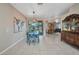 Stylish dining area with blue dining set, open to living spaces, and plenty of natural light at 1962 Remus Ave, North Port, FL 34286