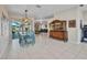 Dining room with bright blue table and chairs, and sliding door leading to the outside patio at 1962 Remus Ave, North Port, FL 34286