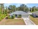Well-maintained single-story home featuring manicured landscaping and an attached two-car garage at 1962 Remus Ave, North Port, FL 34286