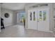 Inviting foyer showcasing tile floors, natural light, and a view into other living spaces at 1962 Remus Ave, North Port, FL 34286