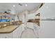 Well-equipped kitchen features white cabinets and mosaic tile backsplash at 1962 Remus Ave, North Port, FL 34286