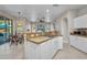 Open kitchen with island seating and adjacent dining area, ideal for gatherings at 1962 Remus Ave, North Port, FL 34286