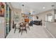 Open-concept living area with dining table and adjacent Gathering room for relaxed living and entertaining at 1962 Remus Ave, North Port, FL 34286