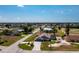 This expansive property includes a home, pool, and lush greenery, nestled within a quiet neighborhood with golf course views at 204 Bunker Rd, Rotonda West, FL 33947