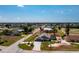 Spacious property features a home with a pool, surrounded by a well-manicured lawn, landscaped areas, and a golf course nearby at 204 Bunker Rd, Rotonda West, FL 33947