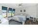 Bright bedroom with blue accents, three large windows and hardwood floors at 204 Bunker Rd, Rotonda West, FL 33947