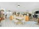 Open dining area featuring a table with six chairs and a view of the front door at 204 Bunker Rd, Rotonda West, FL 33947