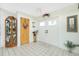 Bright foyer showcasing a tile floor, double doors, and classic decorative elements creating an inviting entrance at 204 Bunker Rd, Rotonda West, FL 33947