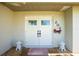 Welcoming double front doors with decorative elements and small shrubs, creating an inviting entrance to the home at 204 Bunker Rd, Rotonda West, FL 33947