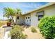 Charming home entrance featuring double doors, manicured landscaping, and decorative accents at 204 Bunker Rd, Rotonda West, FL 33947