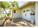 Charming front entrance featuring double doors, decorative shrubbery, and a welcoming ambiance with palm trees at 204 Bunker Rd, Rotonda West, FL 33947
