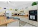 Spacious kitchen featuring an island sink, ample cabinets, and modern appliances at 204 Bunker Rd, Rotonda West, FL 33947