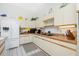 Kitchen featuring a refrigerator, white cabinets, and light countertops at 204 Bunker Rd, Rotonda West, FL 33947