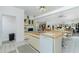Cozy kitchen featuring an island with a sink and an adjacent dining and living area at 204 Bunker Rd, Rotonda West, FL 33947