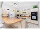 Bright kitchen with a breakfast bar, white cabinets, and modern appliances at 204 Bunker Rd, Rotonda West, FL 33947