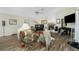 Inviting living room boasts an open floor plan, hardwood floors, and a cozy seating area with a fireplace and piano at 204 Bunker Rd, Rotonda West, FL 33947
