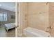 Clean bathroom with a tub shower featuring decorative tiling and glass doors at 23590 Copperleaf Dr, Venice, FL 34293
