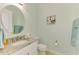 Half bathroom with granite countertop and round mirror at 23590 Copperleaf Dr, Venice, FL 34293