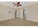 Empty bedroom with tile floors, ceiling fan, and access to an adjacent bathroom at 23590 Copperleaf Dr, Venice, FL 34293