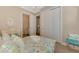 Serene bedroom with coastal accents, queen size bed, and mirrored closet doors at 23590 Copperleaf Dr, Venice, FL 34293