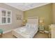 Inviting bedroom features a queen bed with coastal decor and light-filled window with shutters at 23590 Copperleaf Dr, Venice, FL 34293