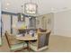 Dining area with a modern chandelier and views of the kitchen, living room, and lanai at 23590 Copperleaf Dr, Venice, FL 34293