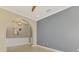 Bright, empty room with with arched entryway and a ceiling fan at 23590 Copperleaf Dr, Venice, FL 34293